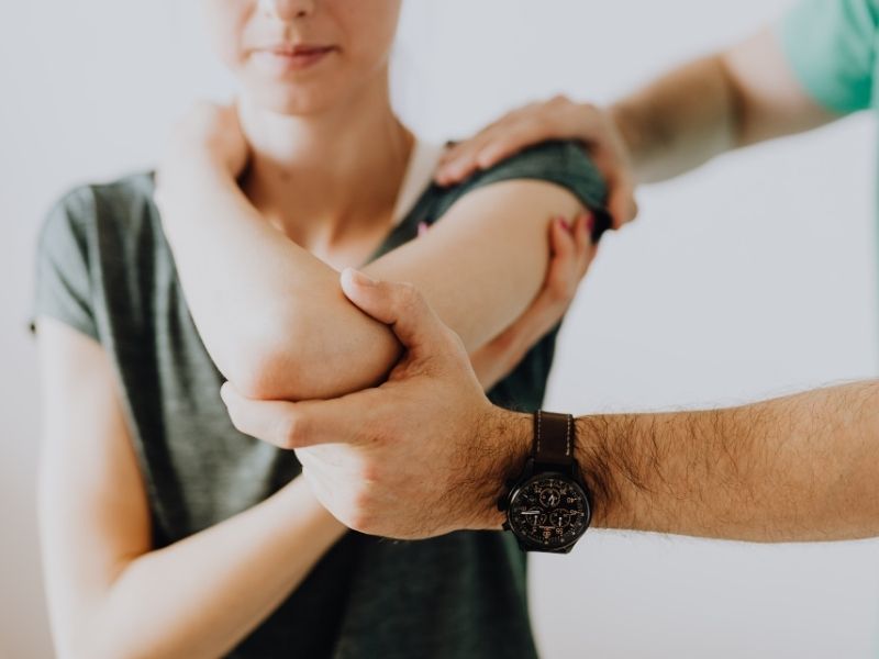 woman receiving chiropractic adjustment on her arm