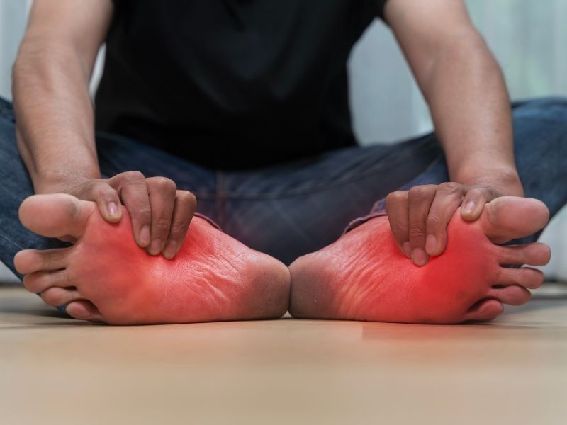 man holding foot in pain