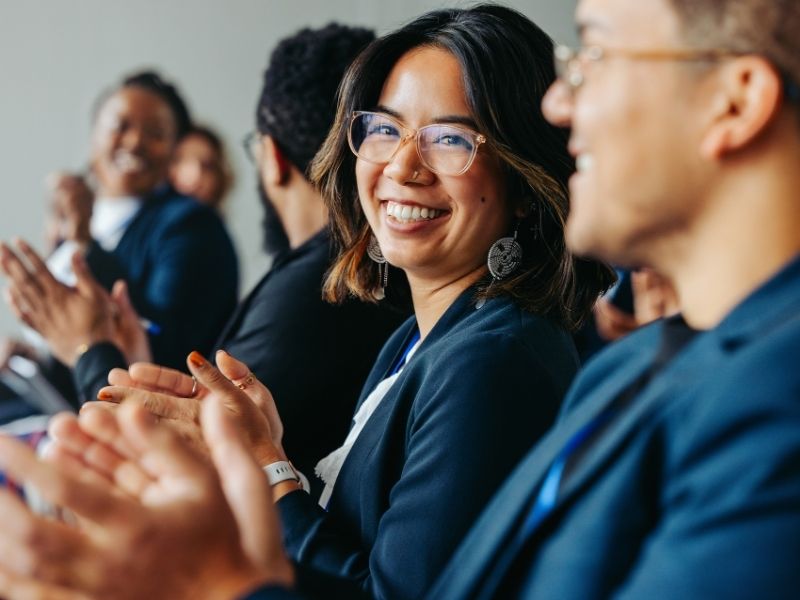 Event attendees smiling and clapping